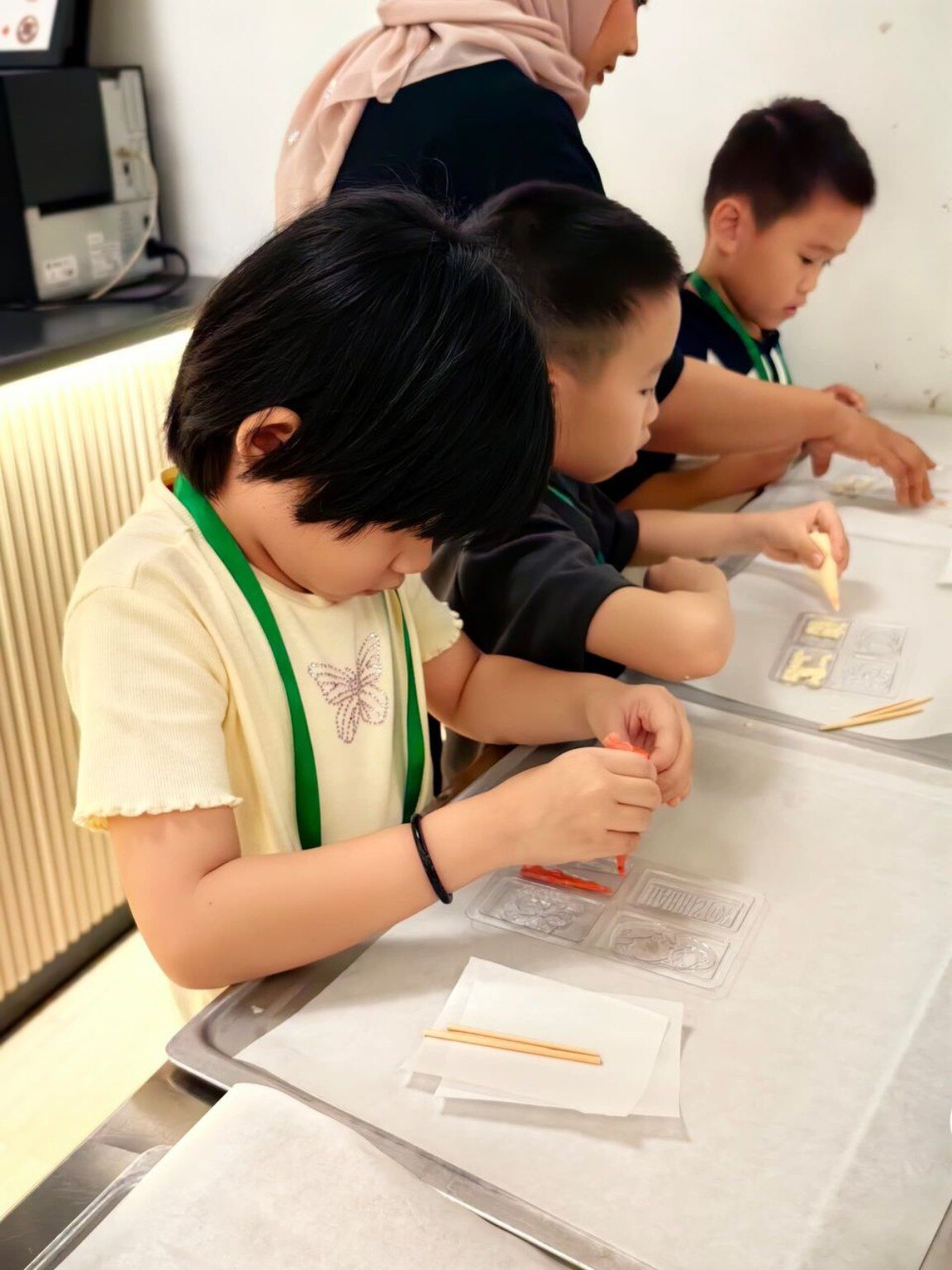 Children concentrating during a hands-on learning workshop